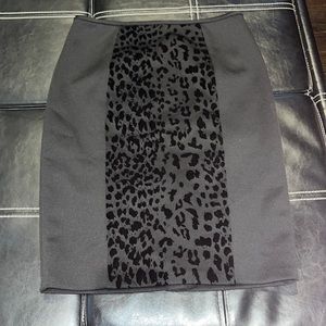 Black pencil skirt with patter down the middle, slit on back.